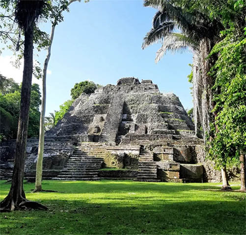 Group exploring ancient Maya temples in Belize jungle
